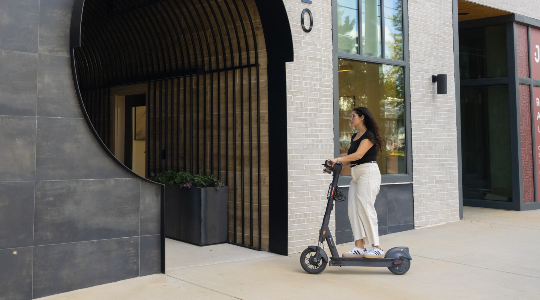 Find your perfect fit at Joinery a person riding a scooter in front of a building